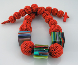 Mardi Gras Delight Beaded balsa wood with vibrantly colored rotating resin cubes made from recycled materials. Length: 17.5″