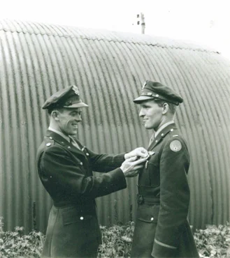 Lieutenant John Simon, pilot of my dad’s plane in the 492nd, awarding him a medal—not sure which one.