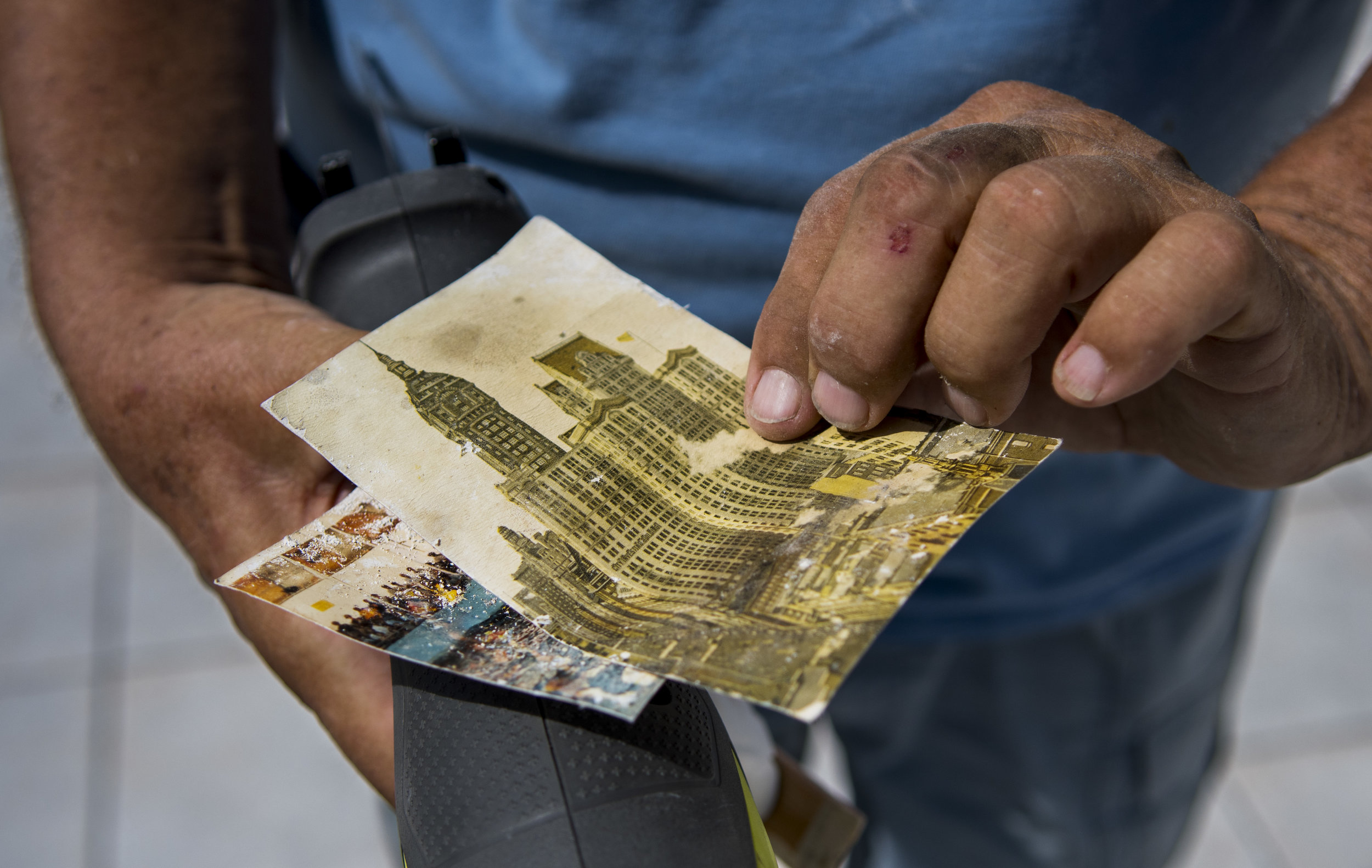  Charlie Chappell examines postcards he recovered from the remains of his home on Big Pine Key. The postcards are from his mother's trip to see the empire state building in 1912. 
