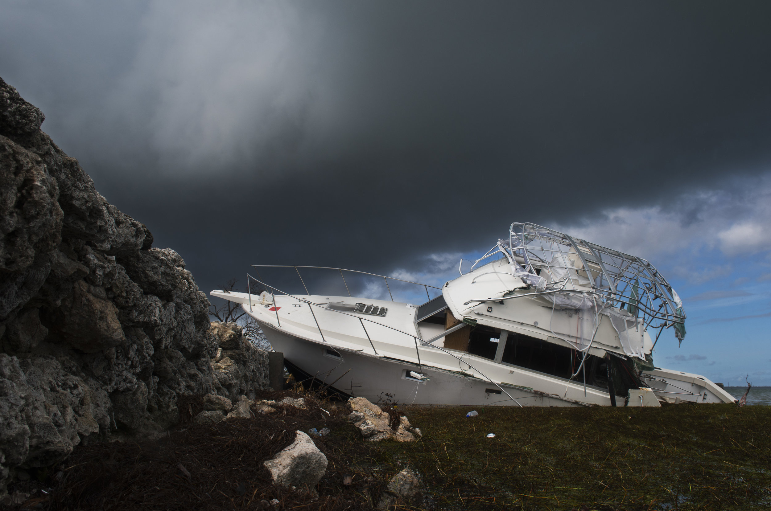  A boat sits capsized near route 1 across the road from the boy-scout reservation on Scout Key. The boat has been featured by numerous media outlets as the vessel was wrecked on an easily accessible piece of shoreline with a little parking lot just i