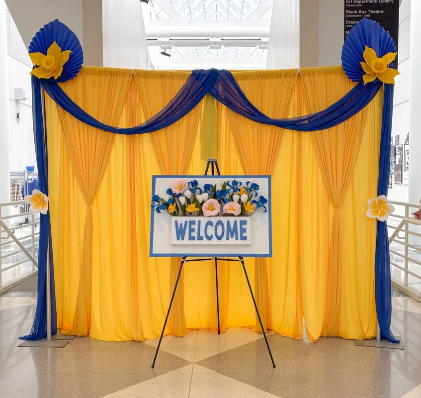 Yellow and blue themed floral event welcome area