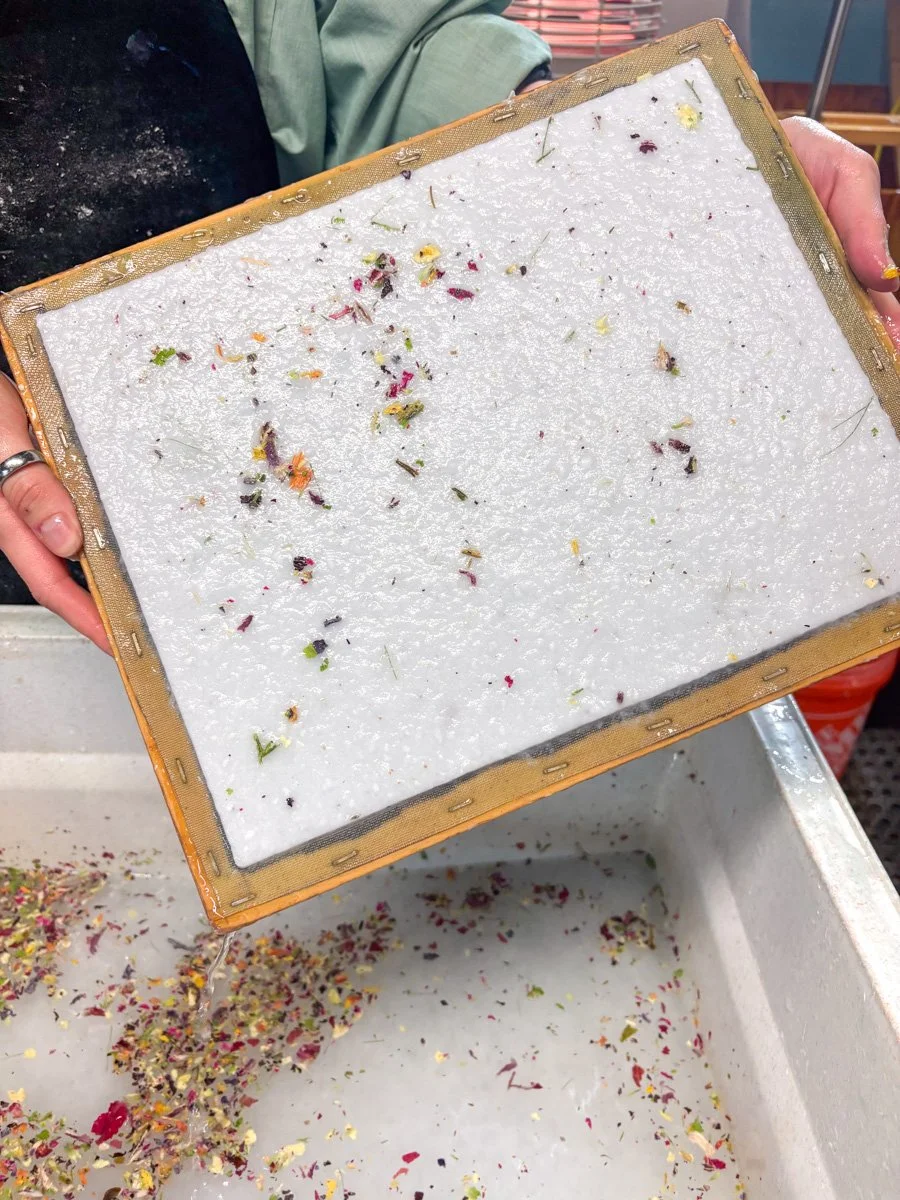 Handmade seed paper with plant material on the screen