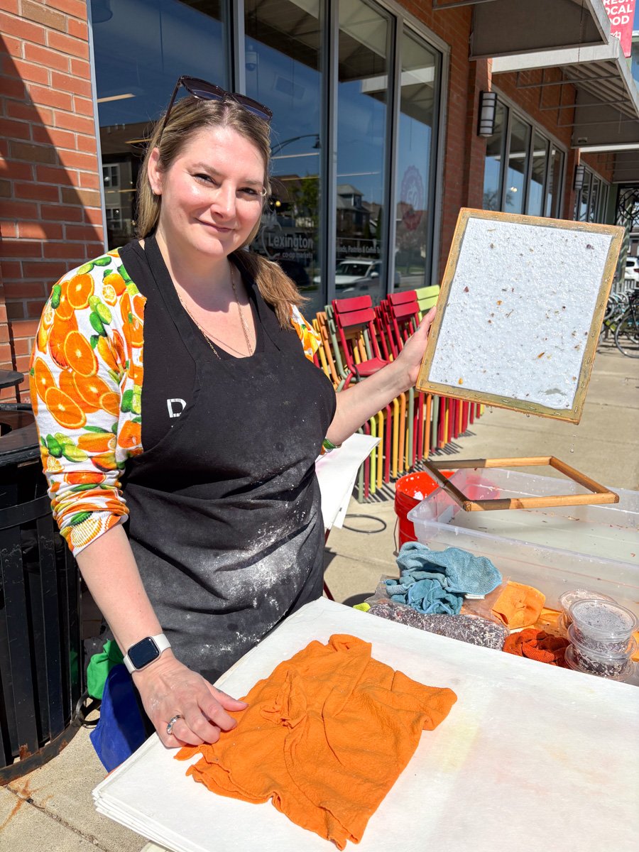 White woman making handmade paper outside