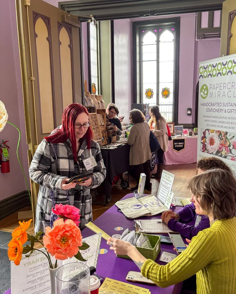 Women registering for an event at the registration table 