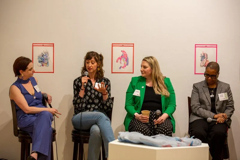 Four people on a speaker panel