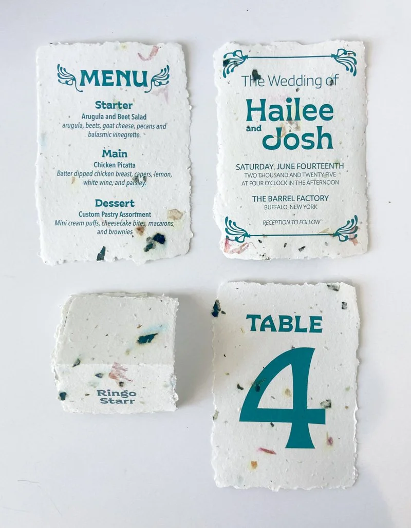 Handmade paper wedding stationery with teal invitation, menu, table number and place card