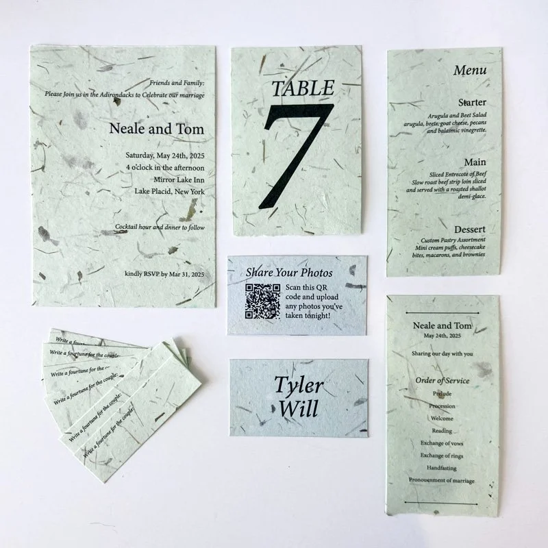 Green handmade paper wedding stationery with invitation, table number, menu, place card and ceremony program