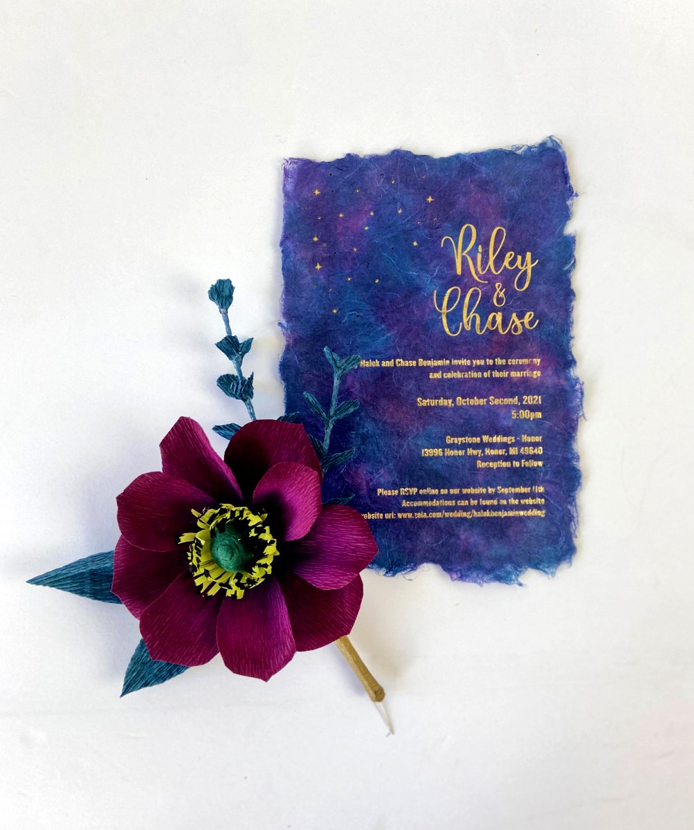 Blue and purple handmade paper wedding invitation for Riley and Chase with burgundy paper flower