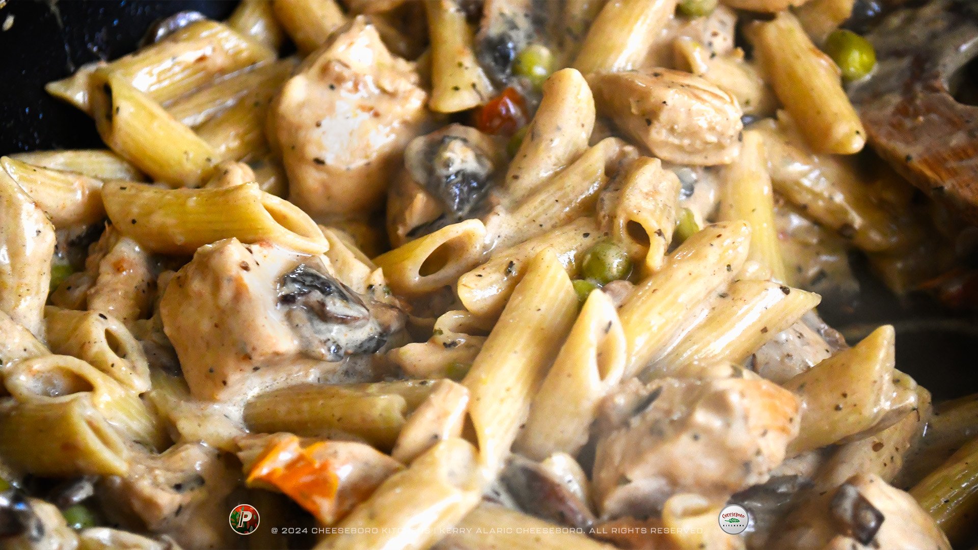 cheeskitch-240201-pizzafetti-penne-chicken-mushrooms-in-pan-cooking-1-1920-hor.jpg