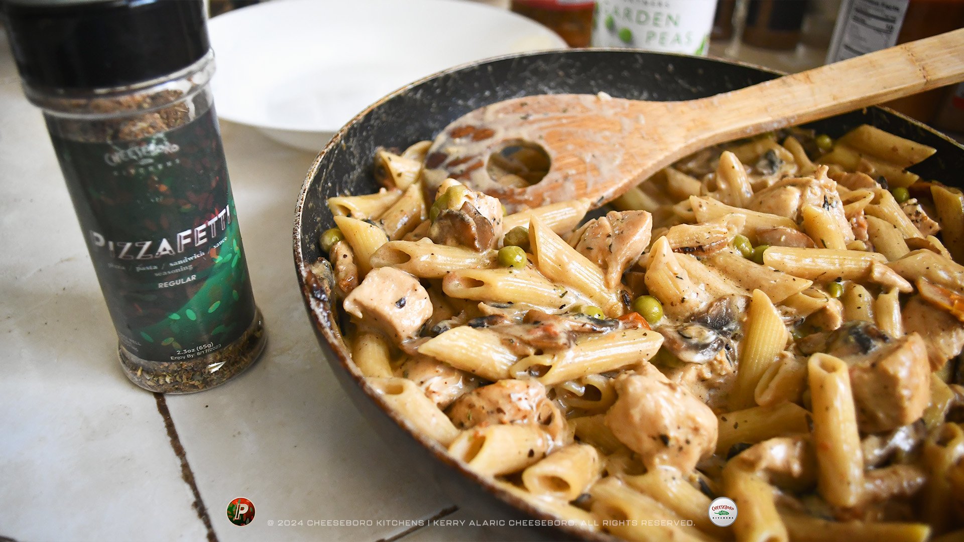 cheeskitch-240201-pizzafetti-penne-chicken-mushrooms-in-pan-with-jar-1-1920-hor.jpg