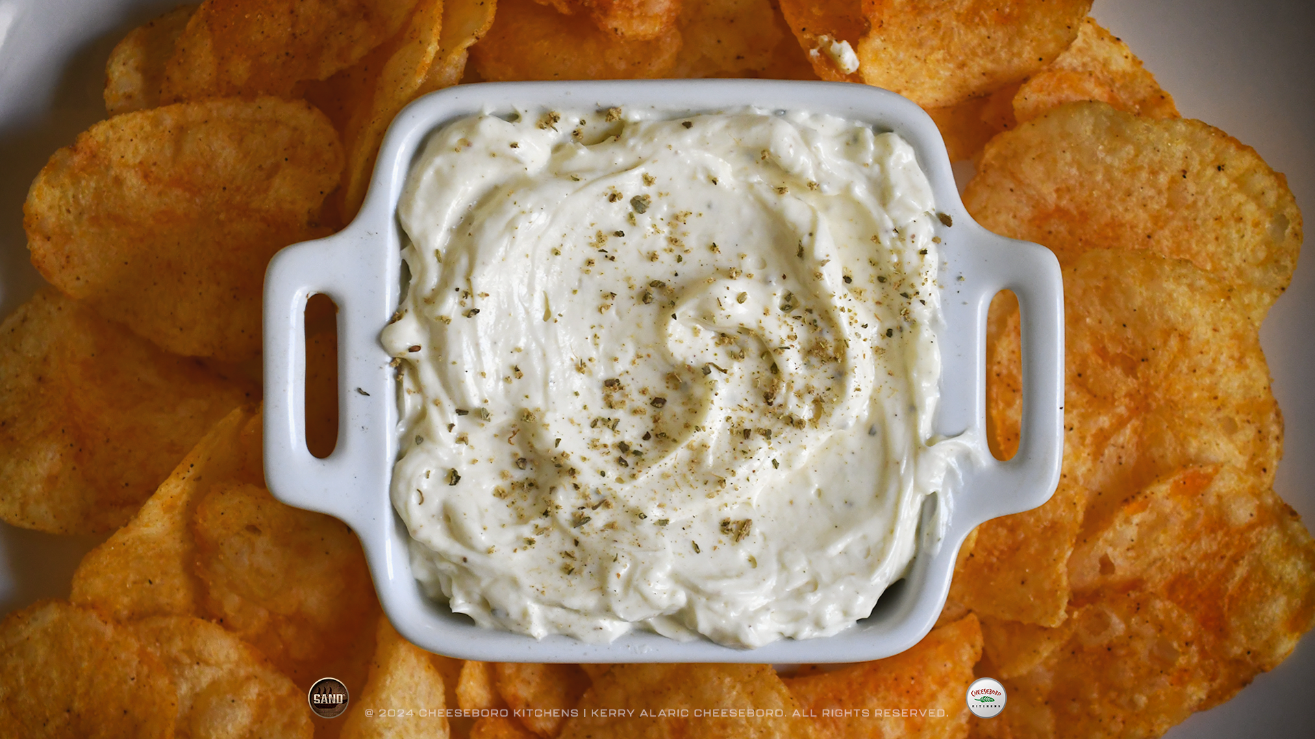 cheeskitch-240212-sand-garden-party-dip-on-plate-with-potato-chips-top-view-1-1920-hor.png