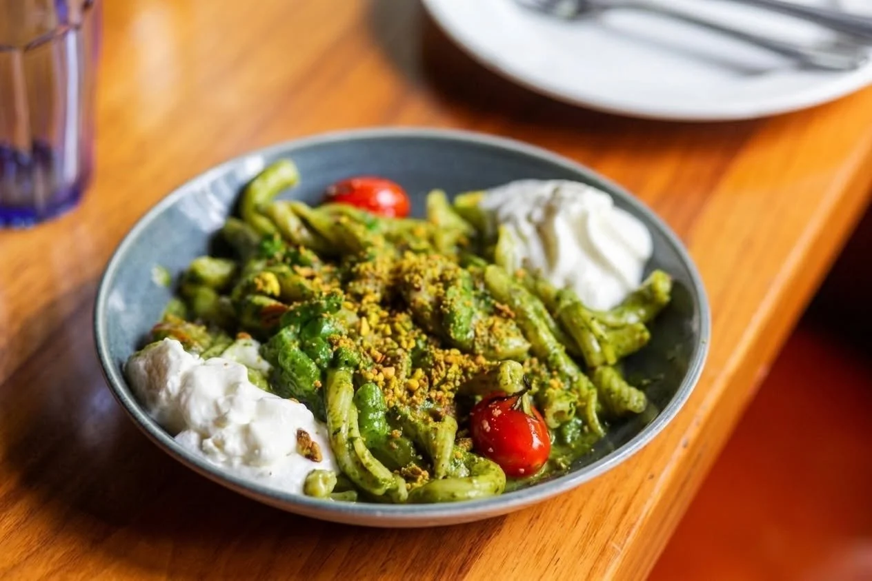 Green on green on green. Garganelli in bright pistachio pesto, crisp green beans, sweet cherry tomatoes, and a cloud of lemon feta. You won't let us take it off the menu and we get it. Pour a crisp, high-acid white alongside. Reserve at alpanachicago