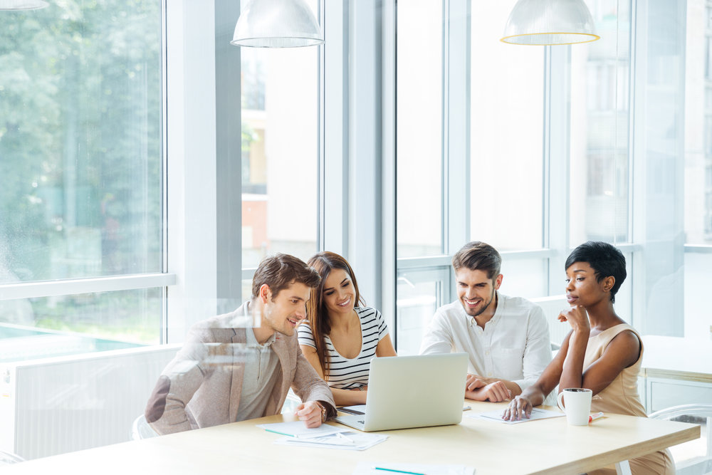 happy-business-team-working-with-laptop-together-P7N6VU9.jpg