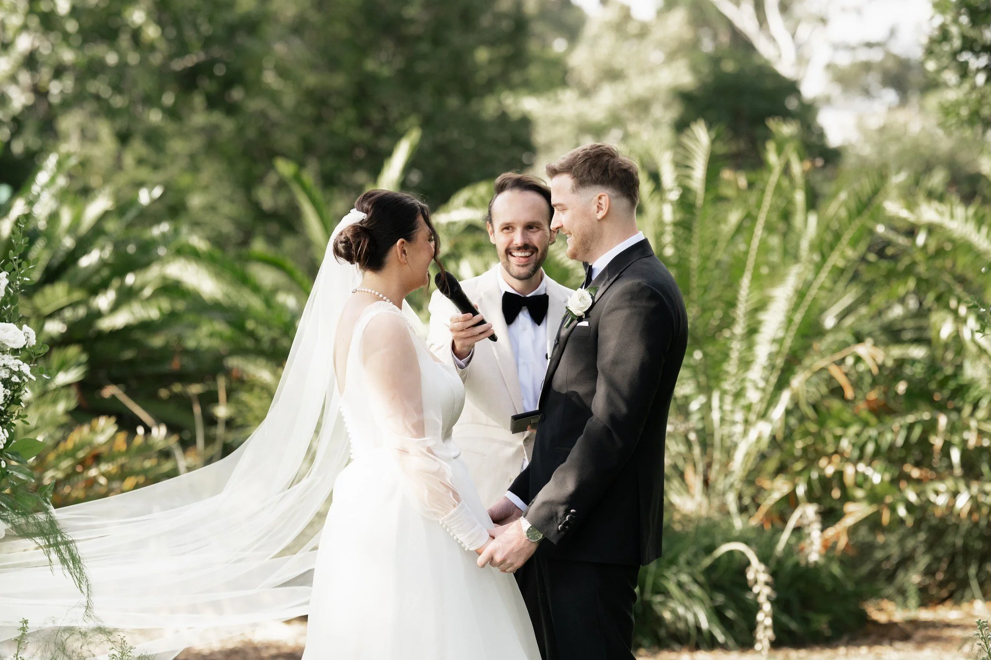 Mr. Samuel James Adelaide Male Marriage Celebrant holding microphone for couple.