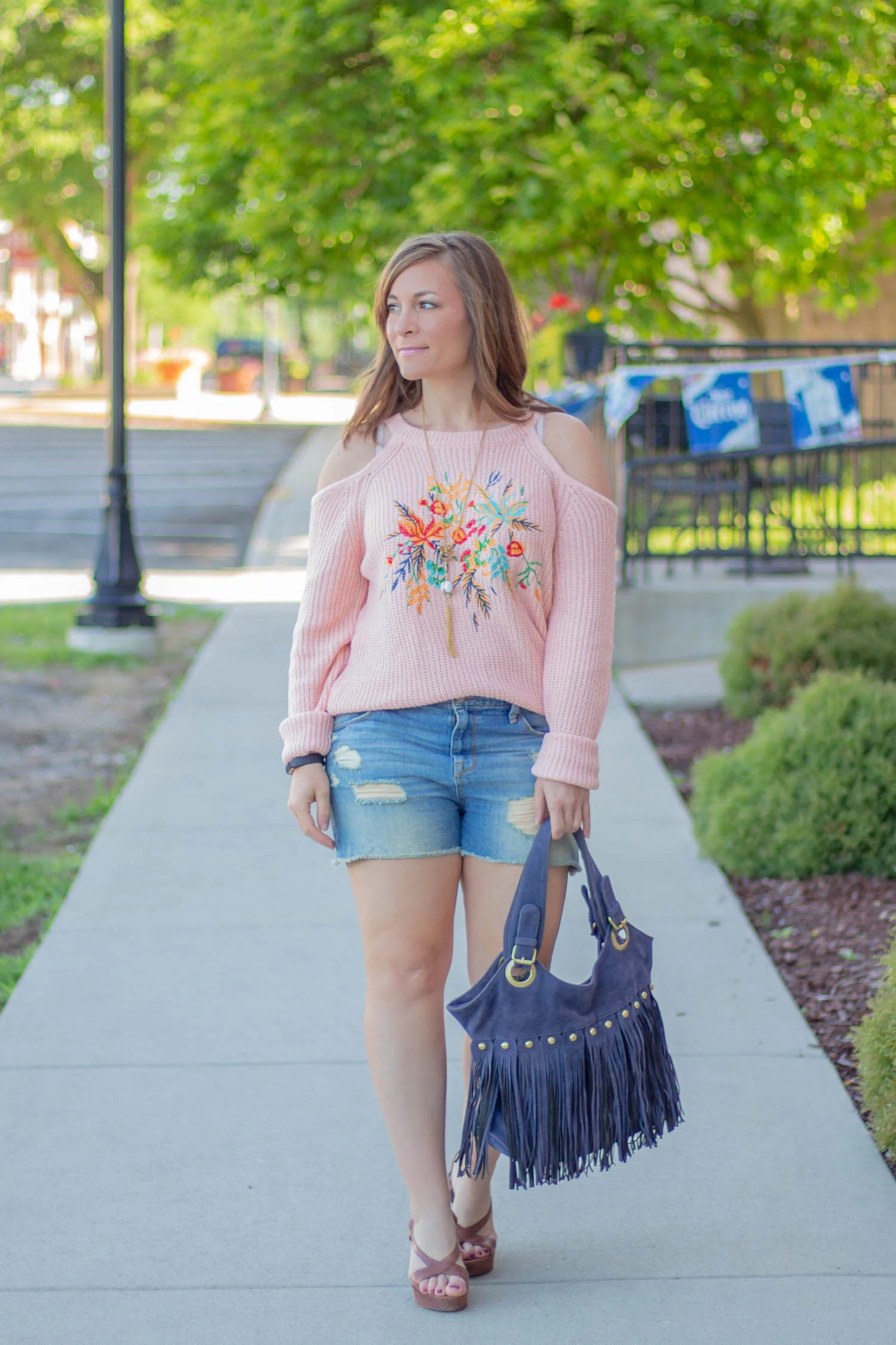 A perfectly cute outfit for summer, especially on cool night, is a cold shoulder sweater with embroidery and cutoffs. Add strappy wedge sandals and viola, summer perfection!