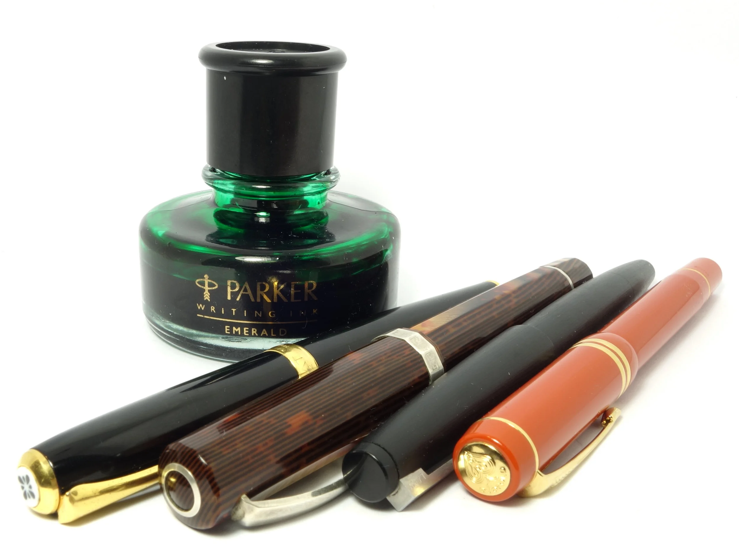 Left to right: Diplomat Excellence A 'M' (KWZ Green #3), OMAS Arte Italiana Paragon Arco Celluloid 'M' (Graf von Faber Castel Moss Green), Lamy 2000 'M' (Bungubox Norwegian Wood/Emerald), and Parker Duofold International 'M' (Parker Penman Emerald).