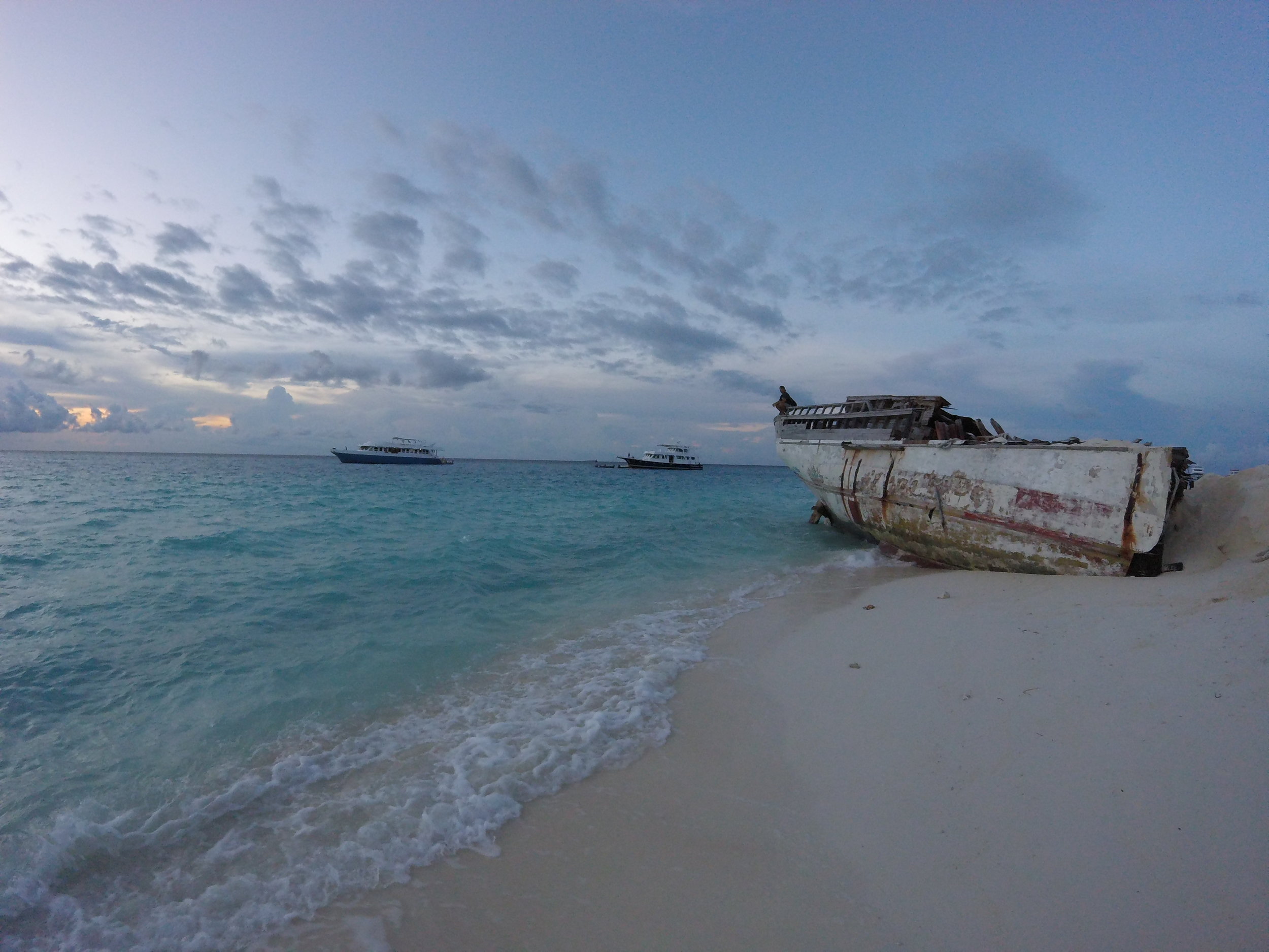 Cute little shipwreck on the other side of the island and a beautiful crystal blue sand beach (the camp side beach is a bit messy and has a bit of coral reef)