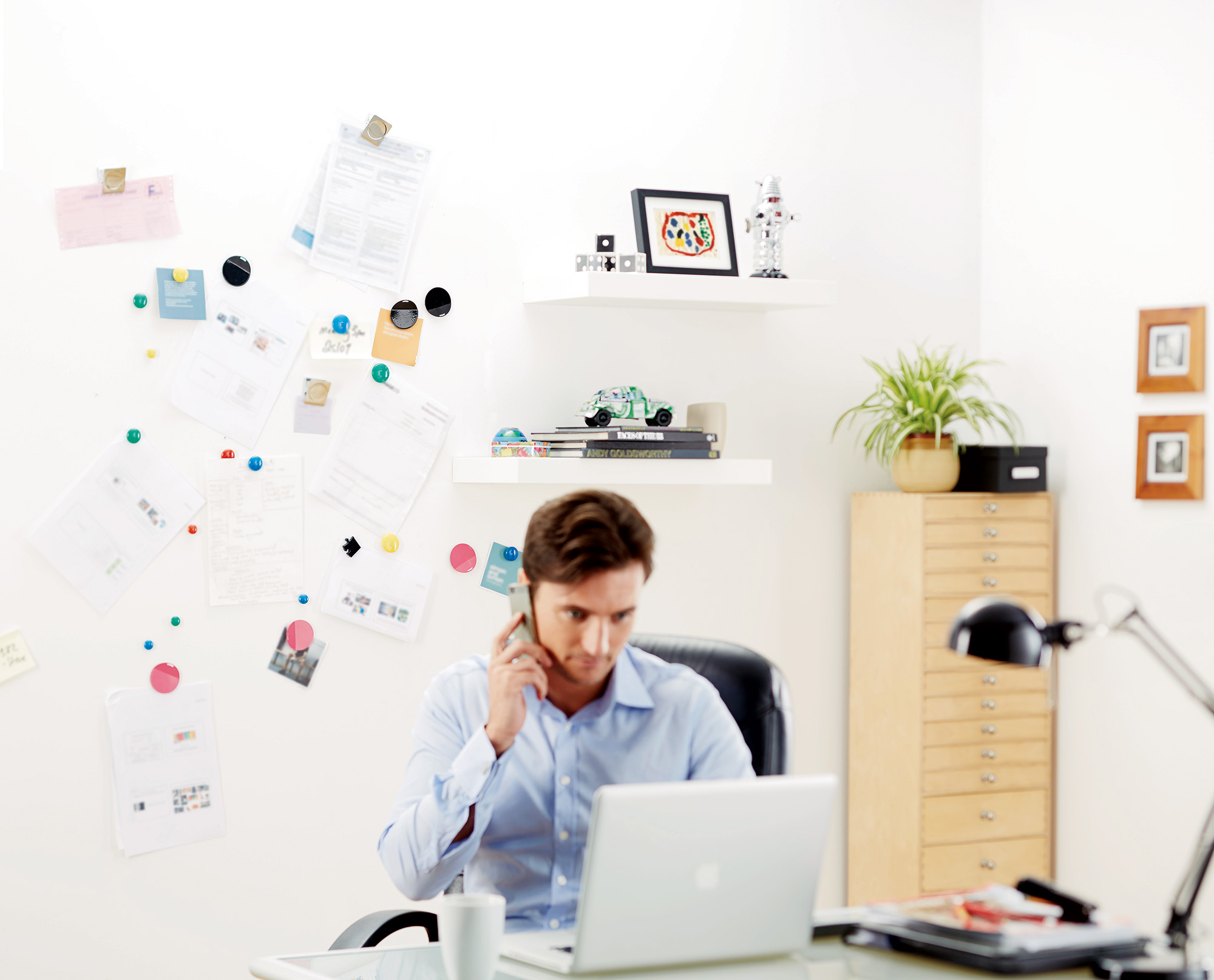 Man in his office with magnetic plaster wall behind him