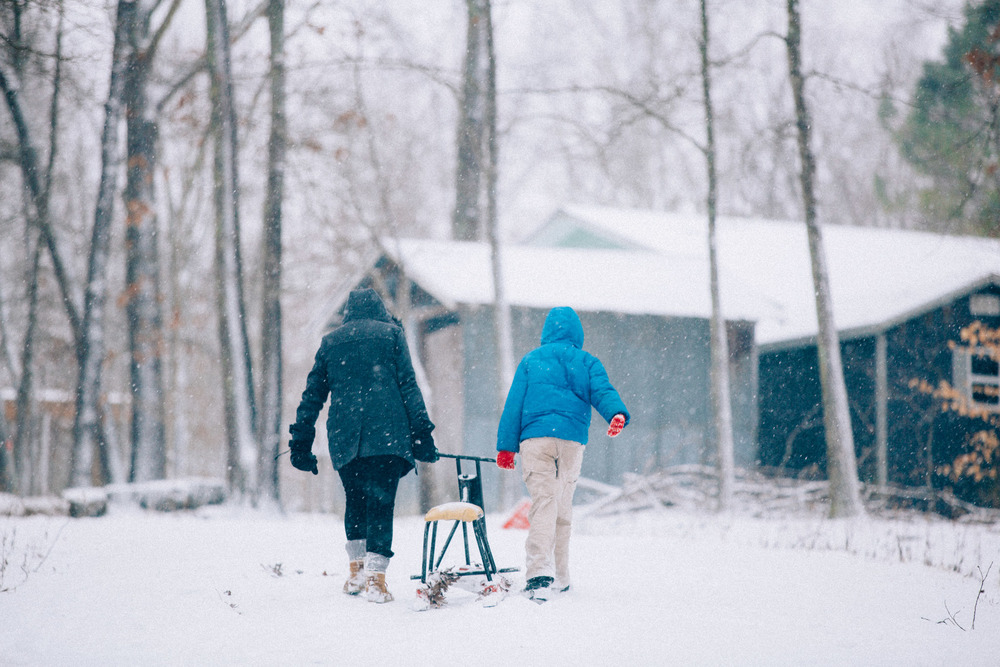 Helping one of The Farm kids pull his sled up the hill