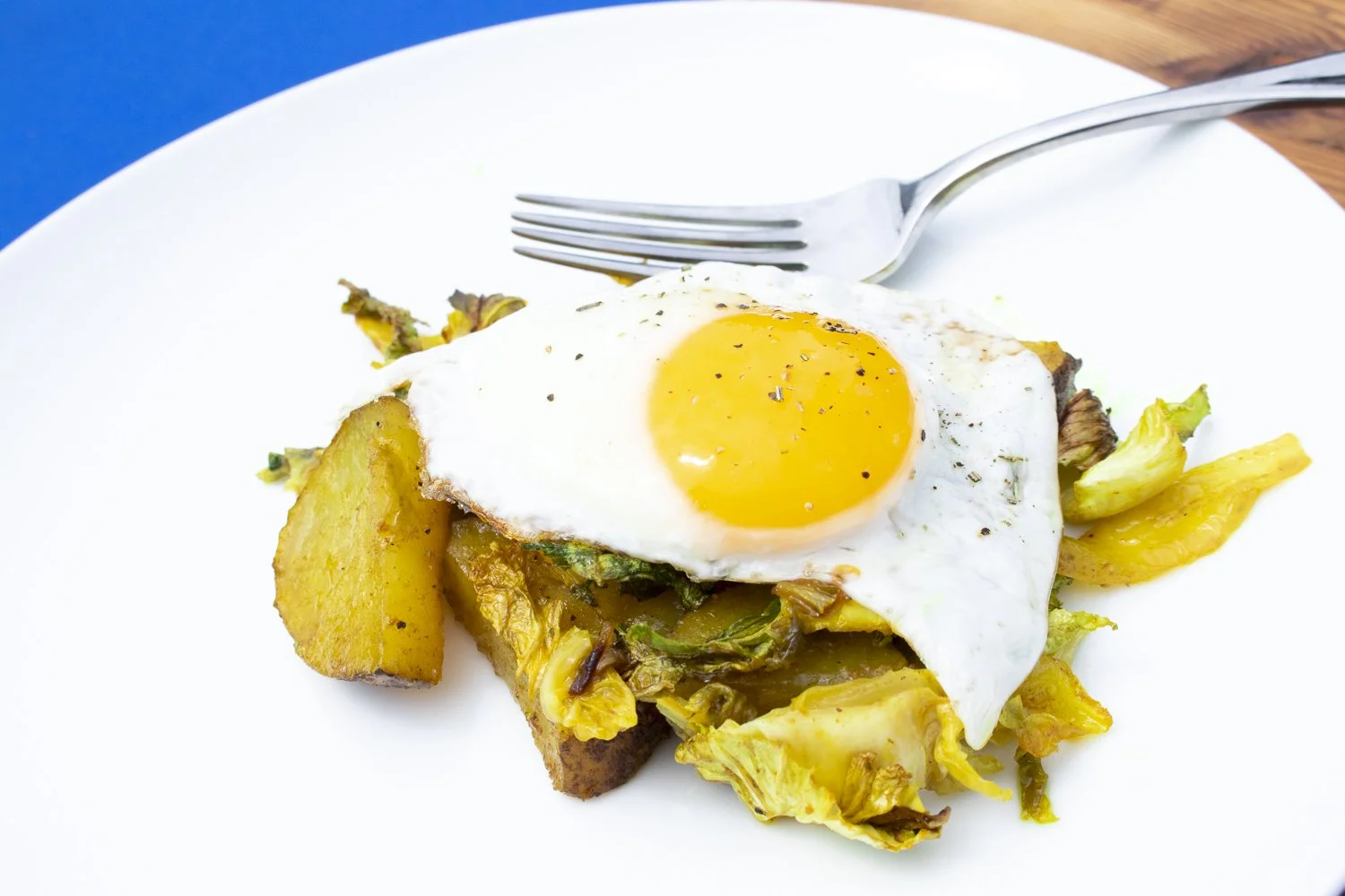 Curried Potato, Cabbage, and Onion Hash with Poached Eggs