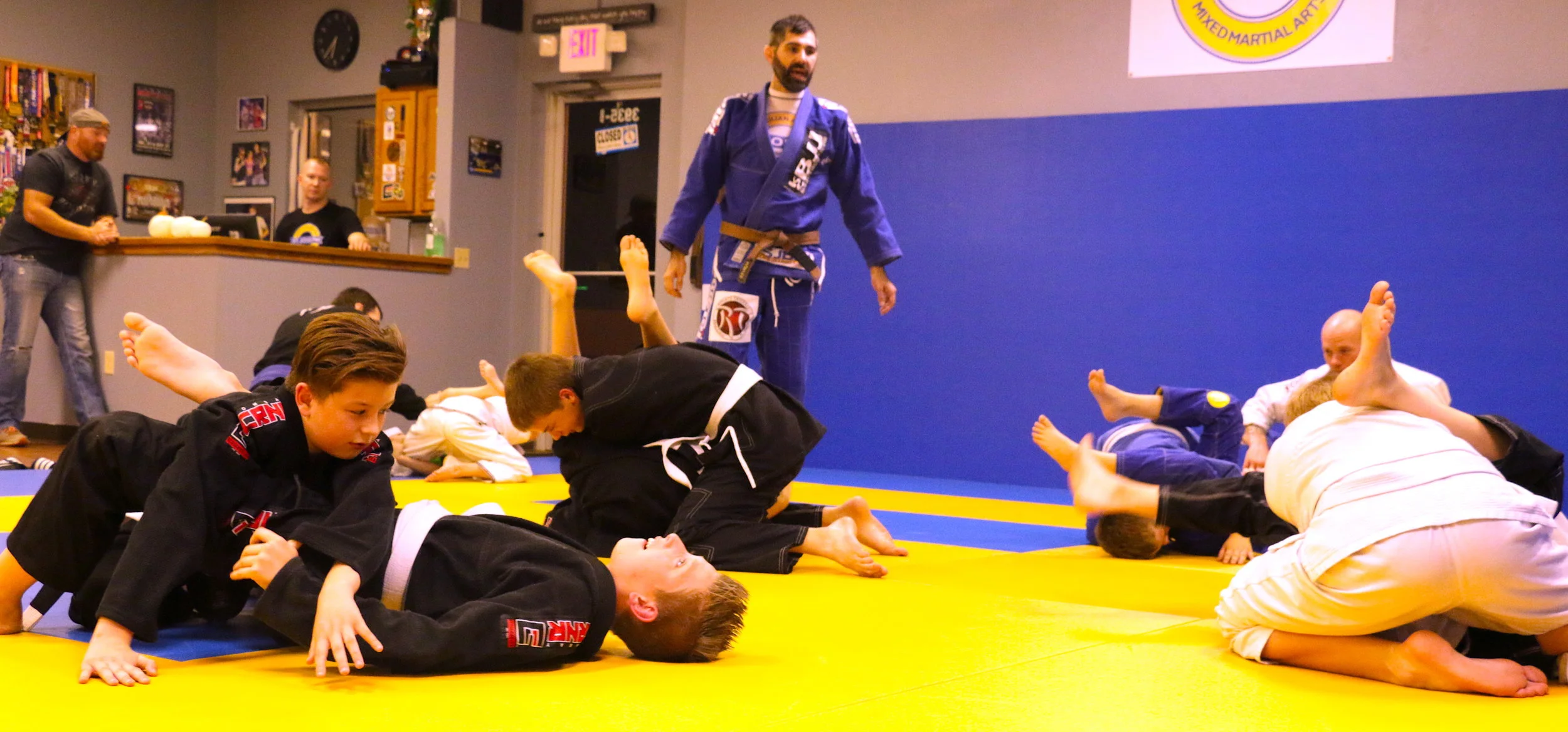 Our 8-15 year olds warming up with armbars and triangles, 2 of our most basic submissions that we try and master through repetition.