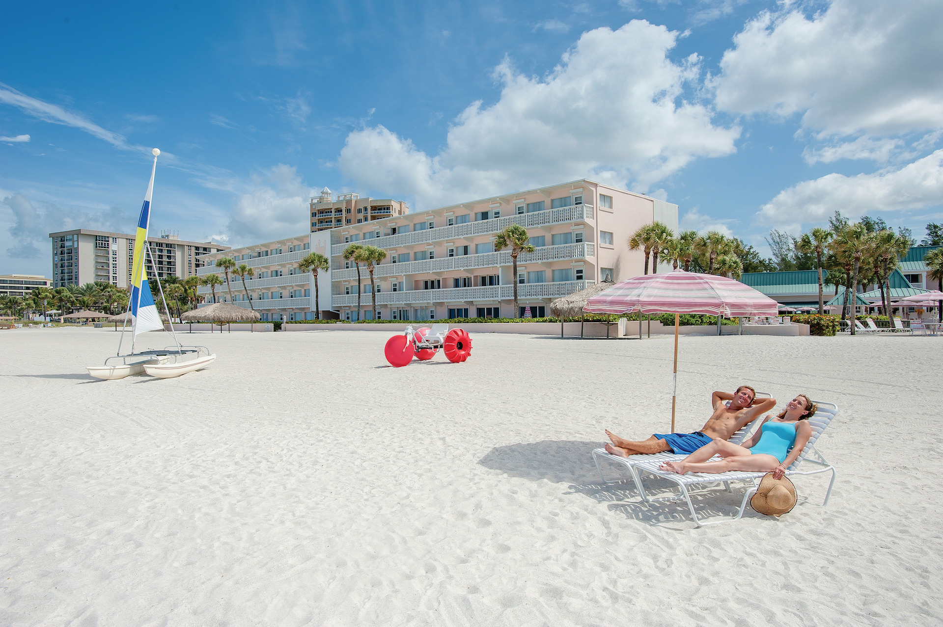 couple lounging on beach chairs at Sandcastle Resort at Lido Beach.jpg