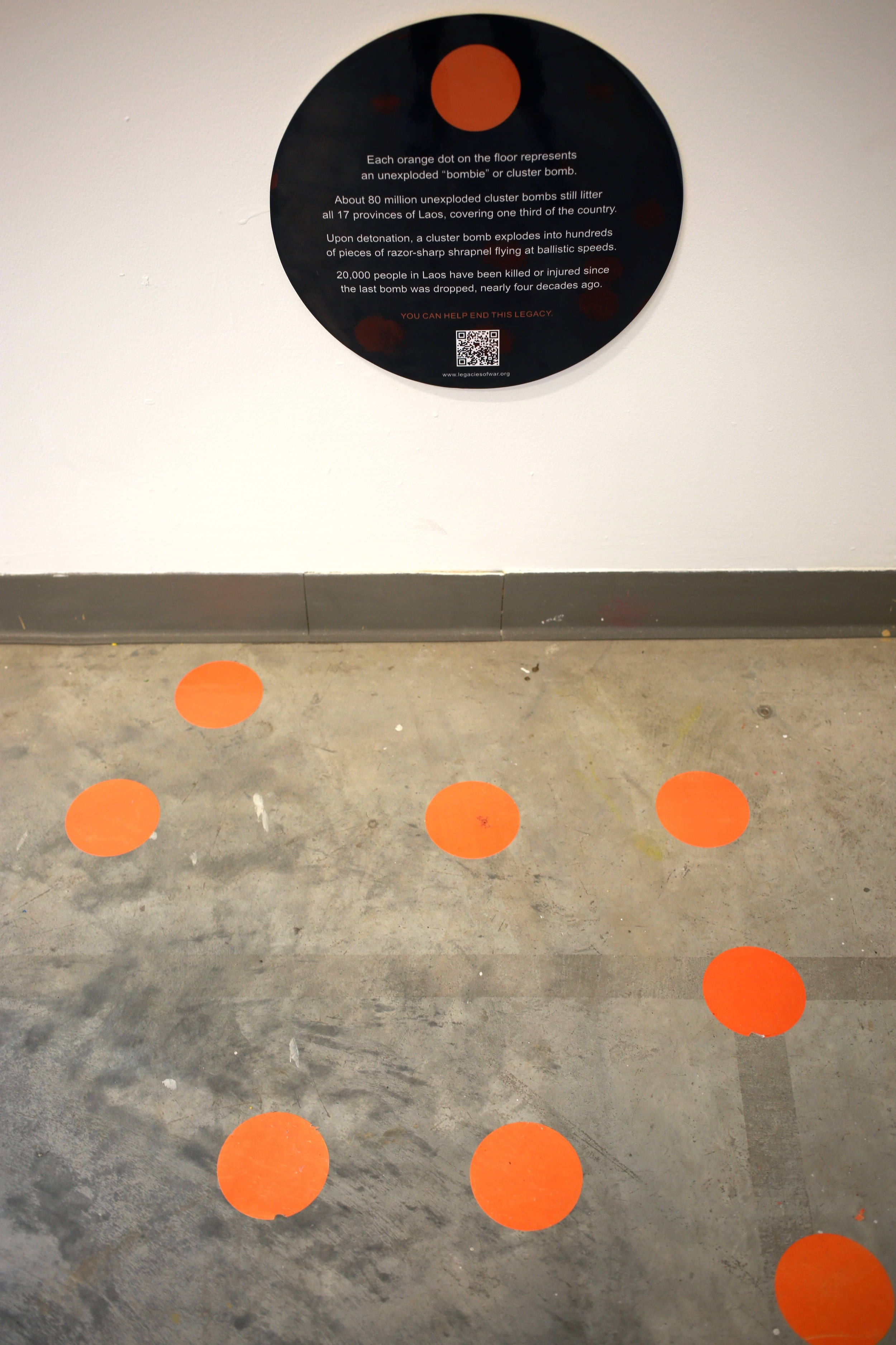 Floor dots representing the unexploded bombs still remaining in Laos, by Legacies of War