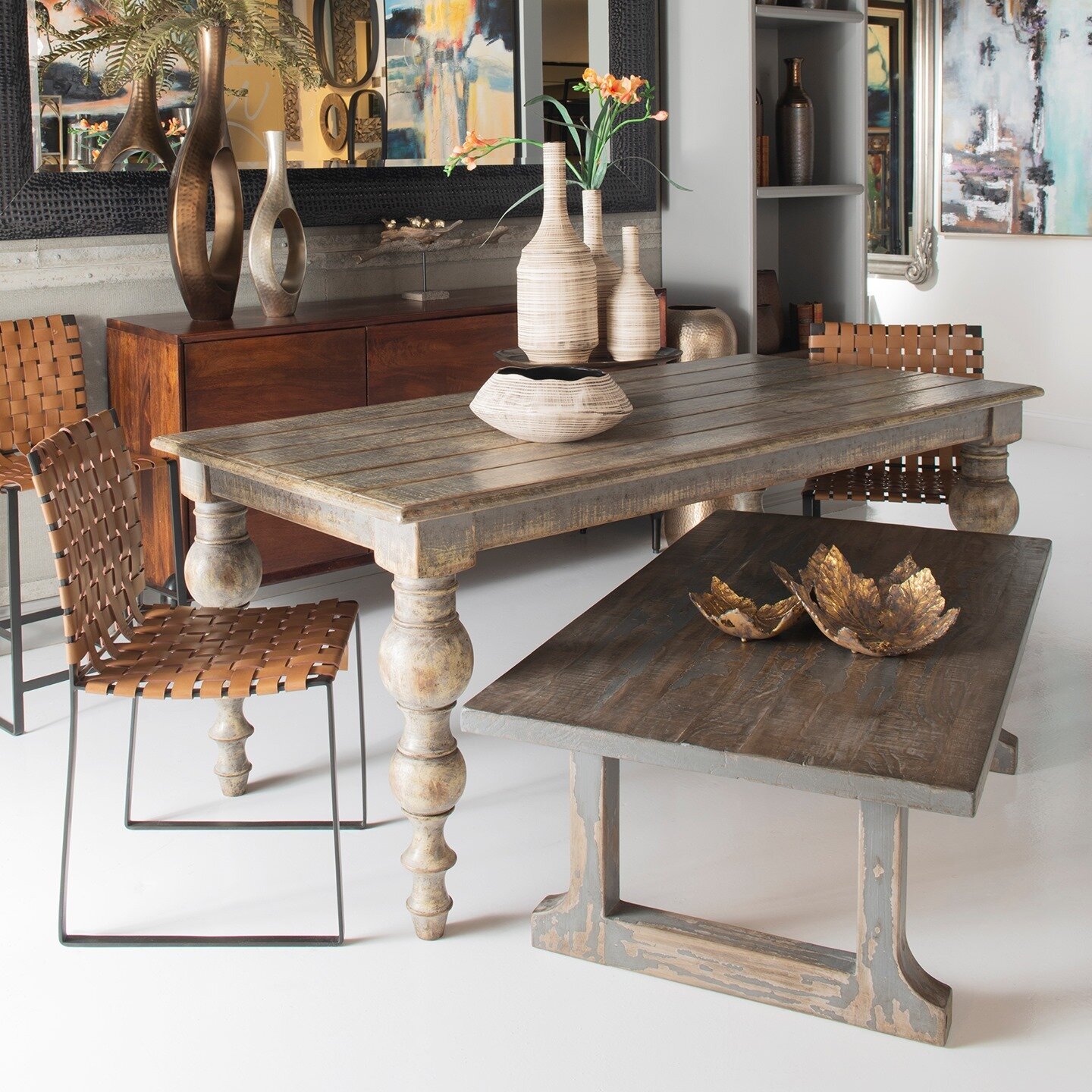 Our antique buying trips throughout the world have opened our eyes to a number of styles and finishes that are still sought after to this day. 

This table collection with its distressed wood and gray finish on a farmhouse styled design is creating a
