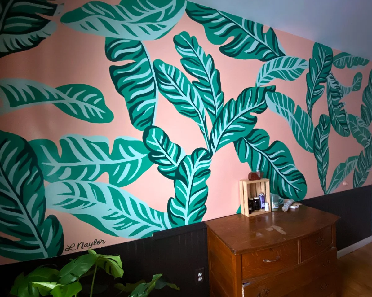 Tropical bathroom mural in Marquette Michigan with banana leaves on pink