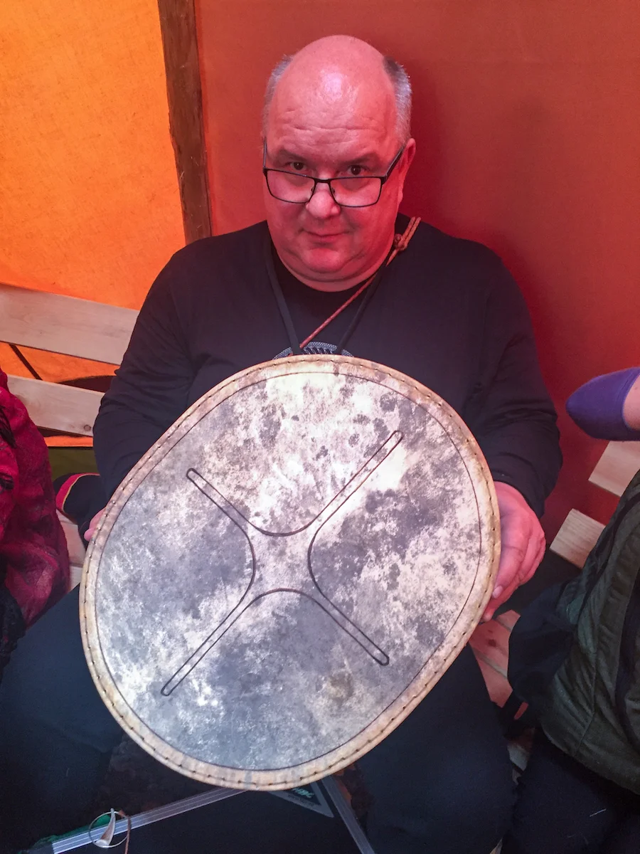 Krister Stoor holds a Sámi drum.