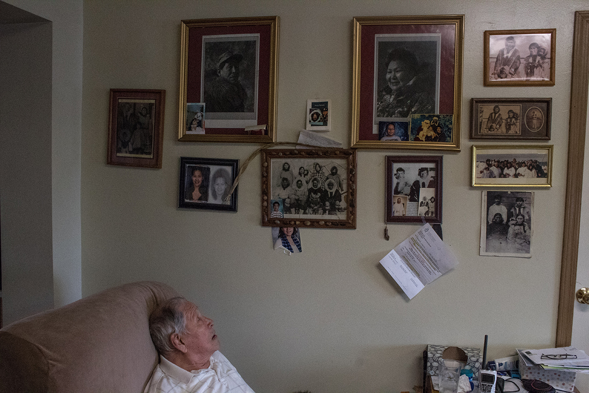 David Leavitt looks at family photos in his home.