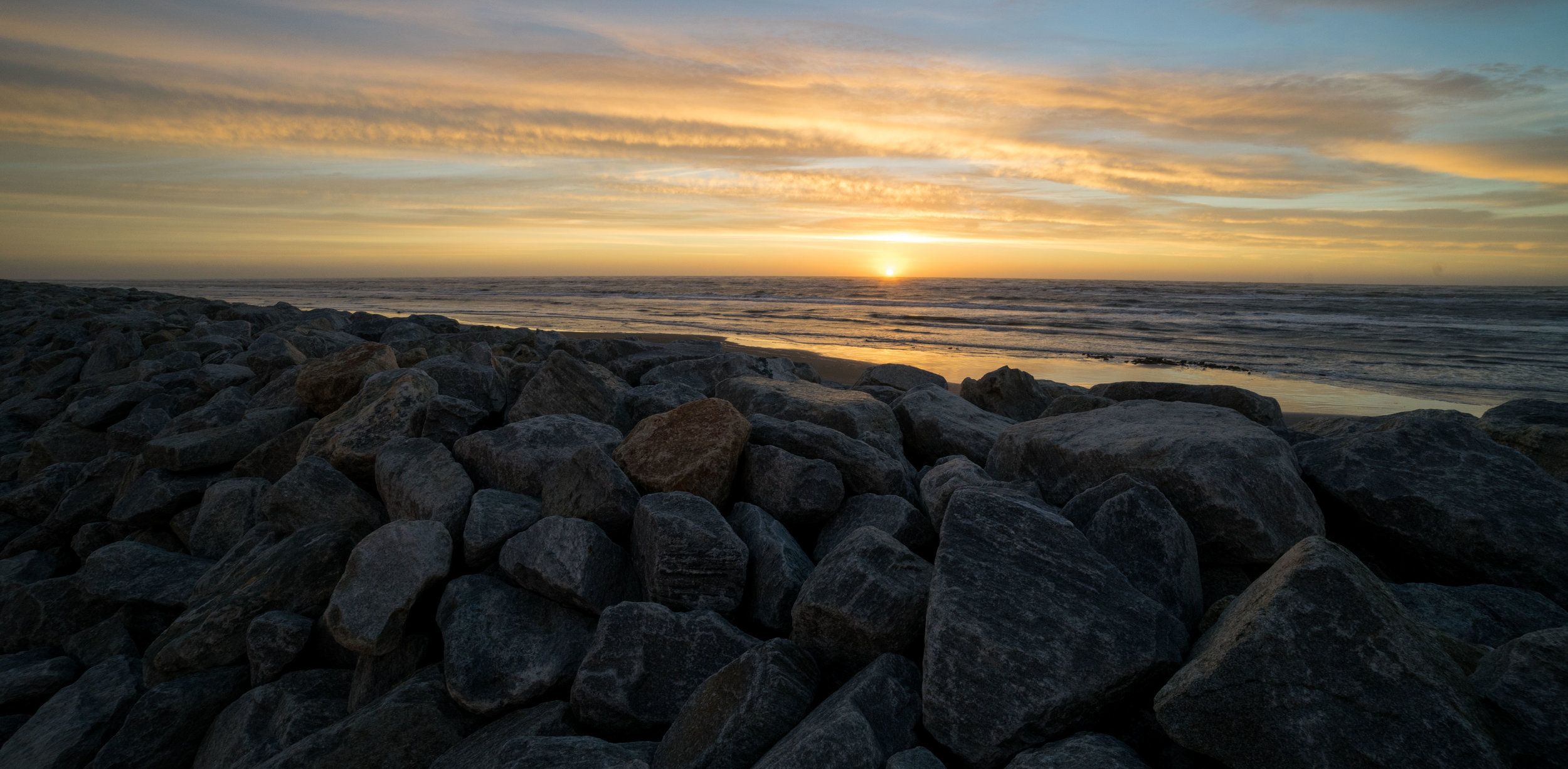 The sea wall, just like the coast, is gradually wearing away.