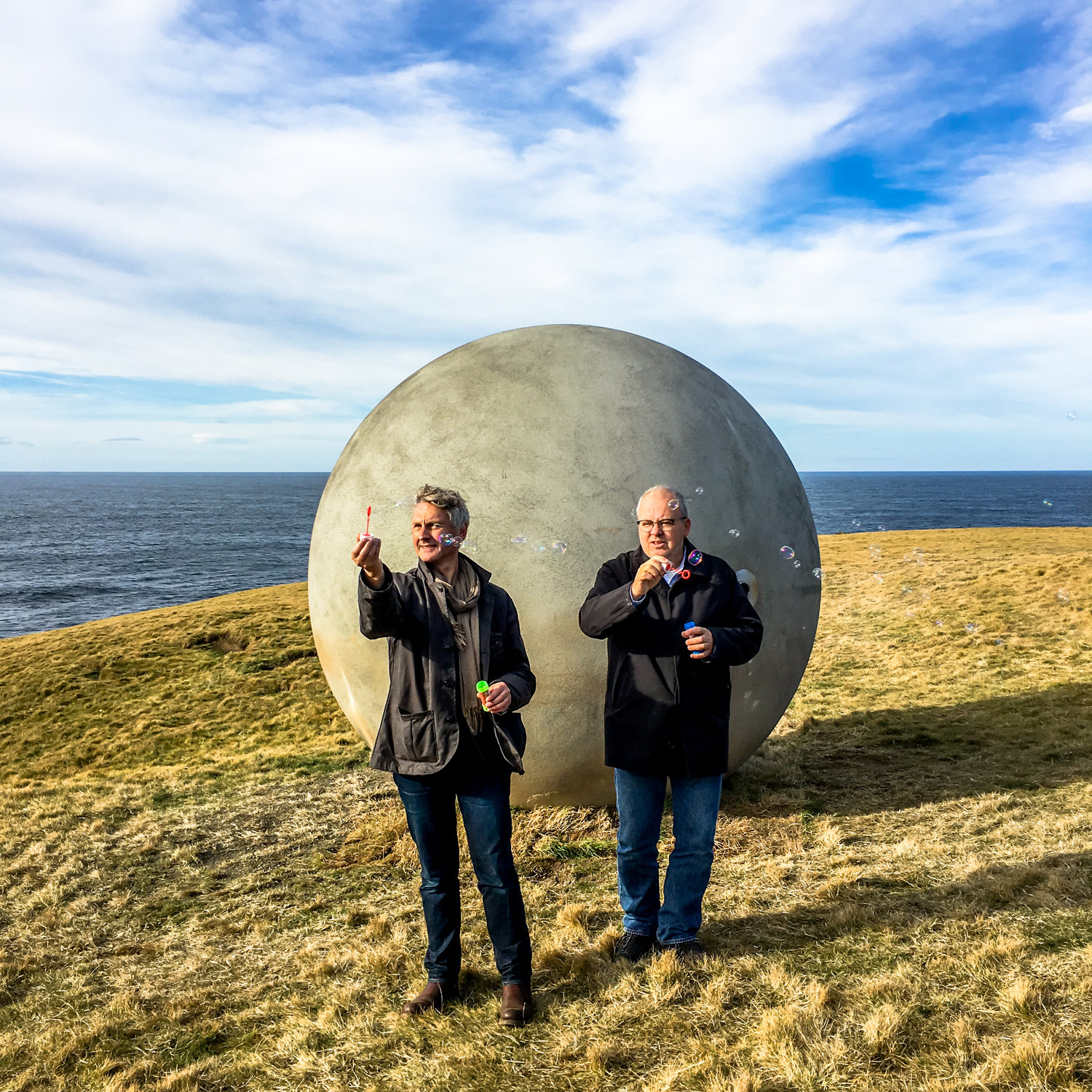 Steve Christer and Kristinn Hrafnsson blow bubbles on installation day.