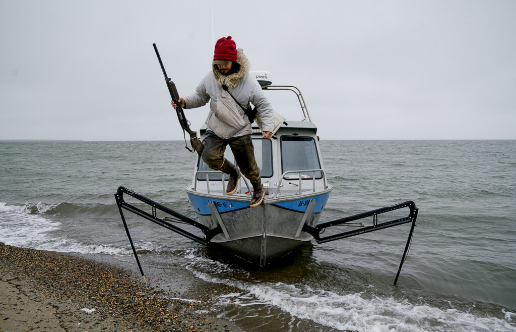 Vebjørn Aishana Reitan, polar bear guide and certified U.S. Coast Guard captain, dismounting his boat.