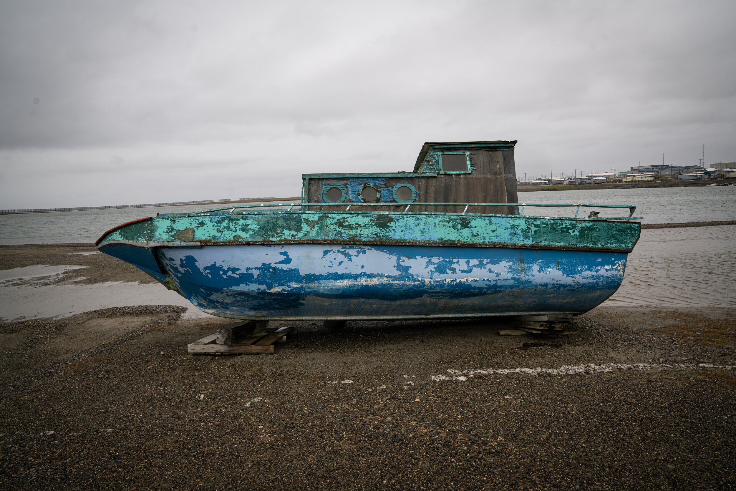 Isolated boat staying on the shore nearby Kaktovik.