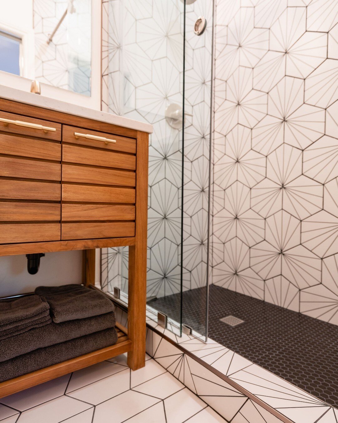 Check out this gorgeous shower tile. We love the contrast with the dark shower floor tile and the wood vanity. Slider doors at the shower are a great way to save space and keep a clean open view to show off the shower tile.

#bathroomrenovation #home