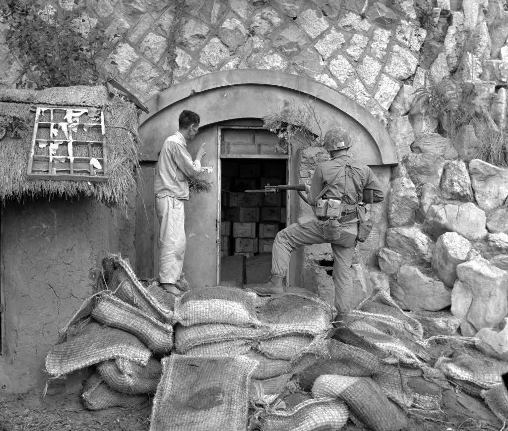 A civilian revealing a dynamite cache to a U.S. Marine near Inchon (1950) Photo Credit: BR3 Project