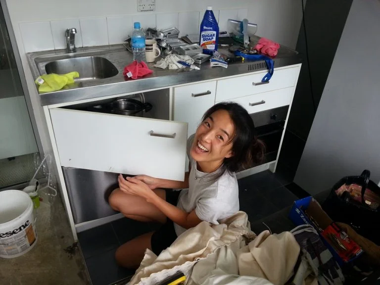 Jason's partner Kylie cleaning the kitchen in their newly purchased investment.&nbsp;Who said landlords just sit back and collect the rent?!