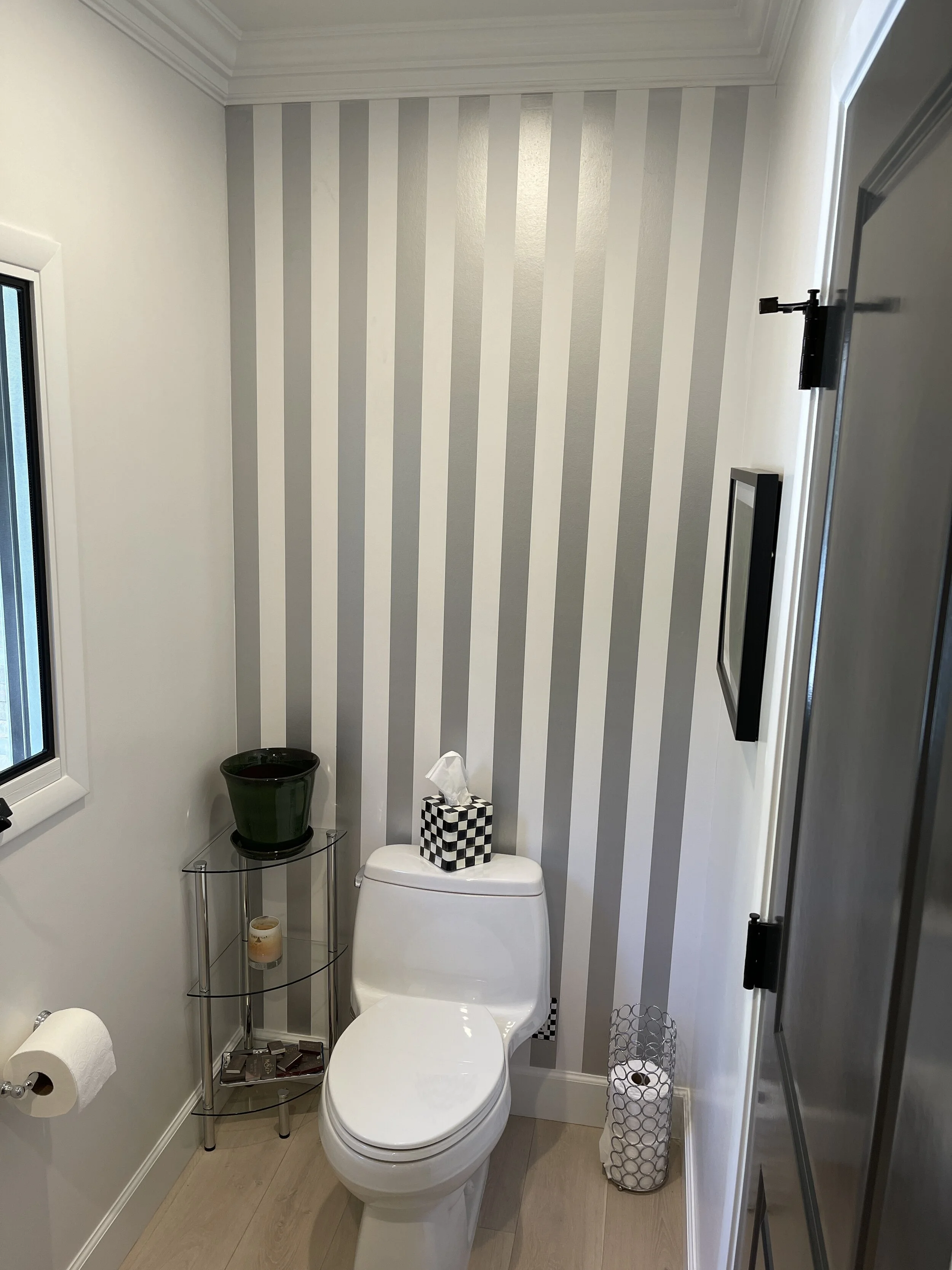  A new powder room was created from the old entry foyer space 