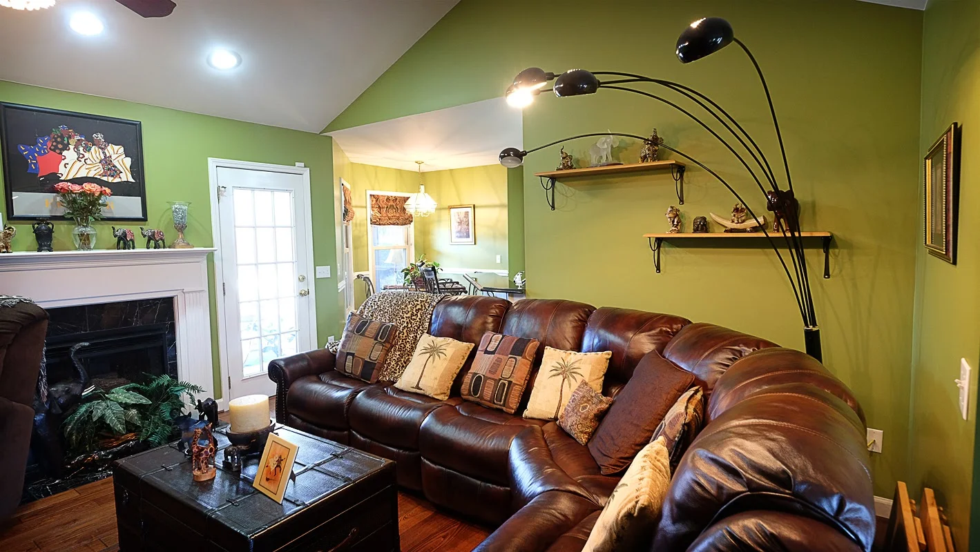 Green room with leather sectional & fireplace - Residential painting by Nash Painting Nashville TN