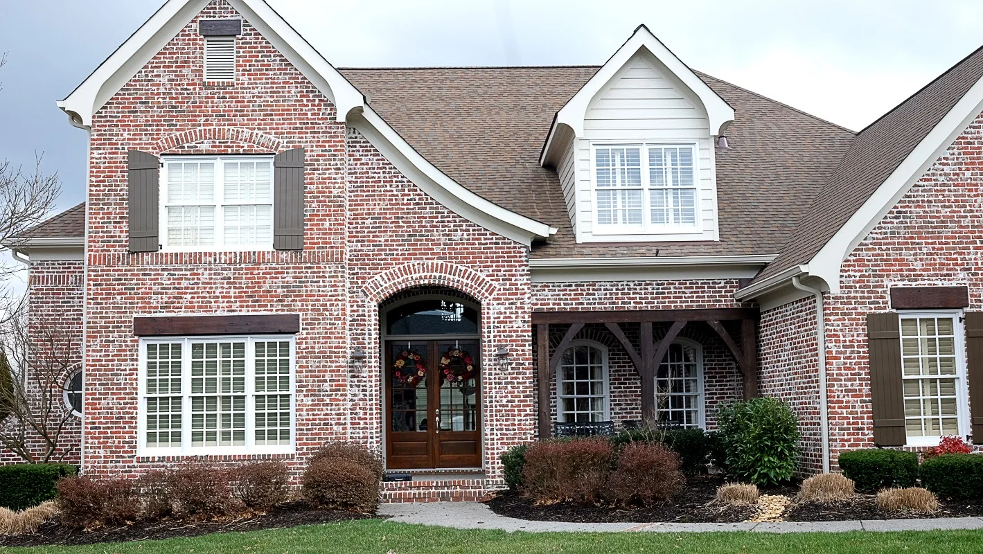Exterior white trim and stained wood trim on a brick house - Residential painting by Nash Painting Nashville TN