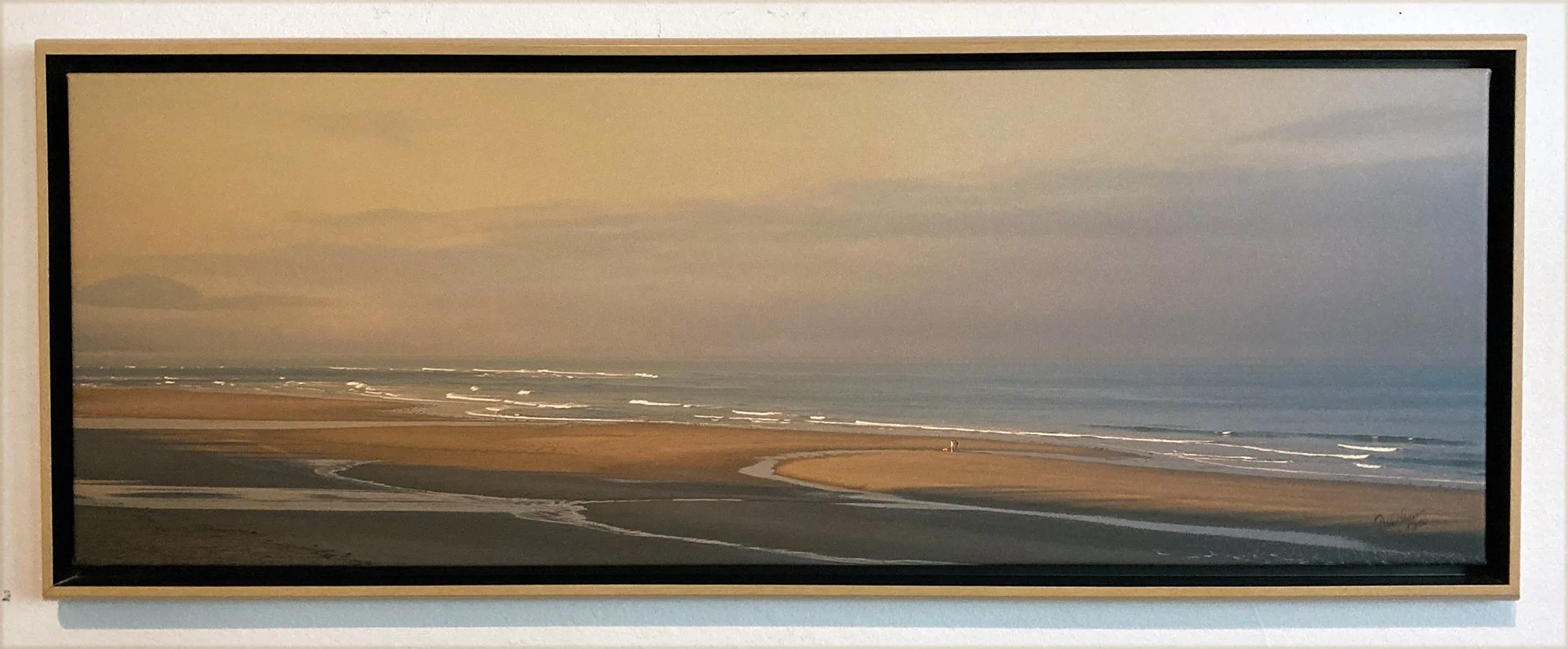 Couple walking dog at sunrise on Oregon Coast