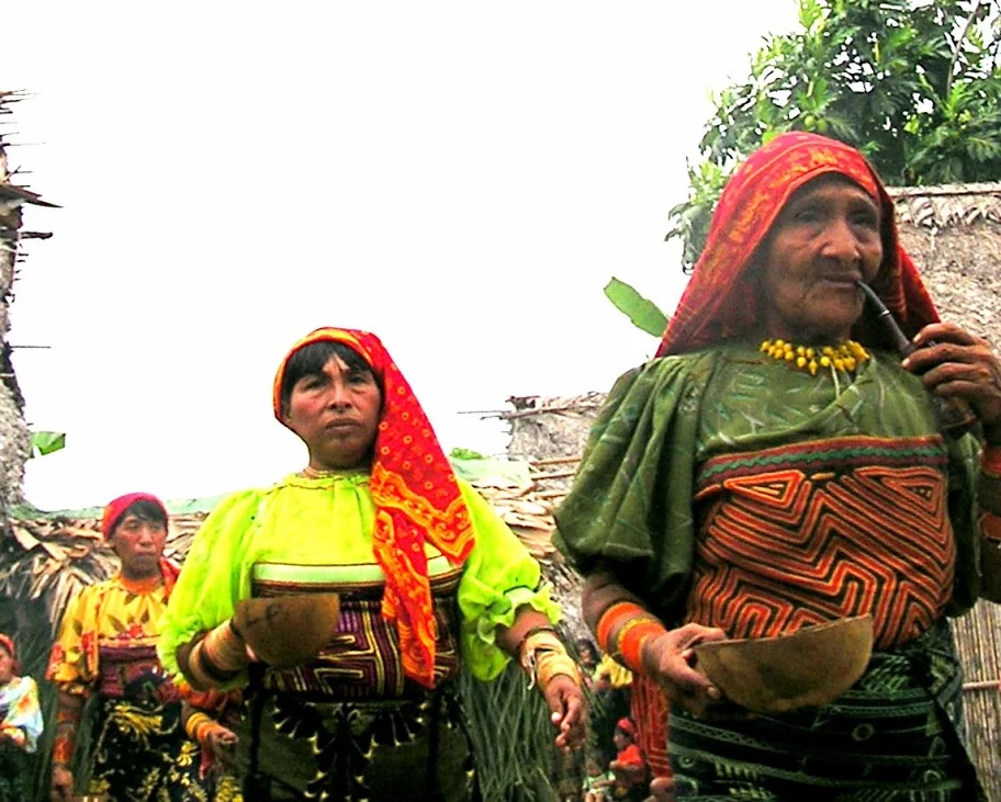 The Kuna women are taking part in a Chicha Fest, soon their bowls will be filled with Chicha, an intoxicating beverage. The fest celebrates the time a young girl becomes a woman. It involves much drinking, smoking and dancing!