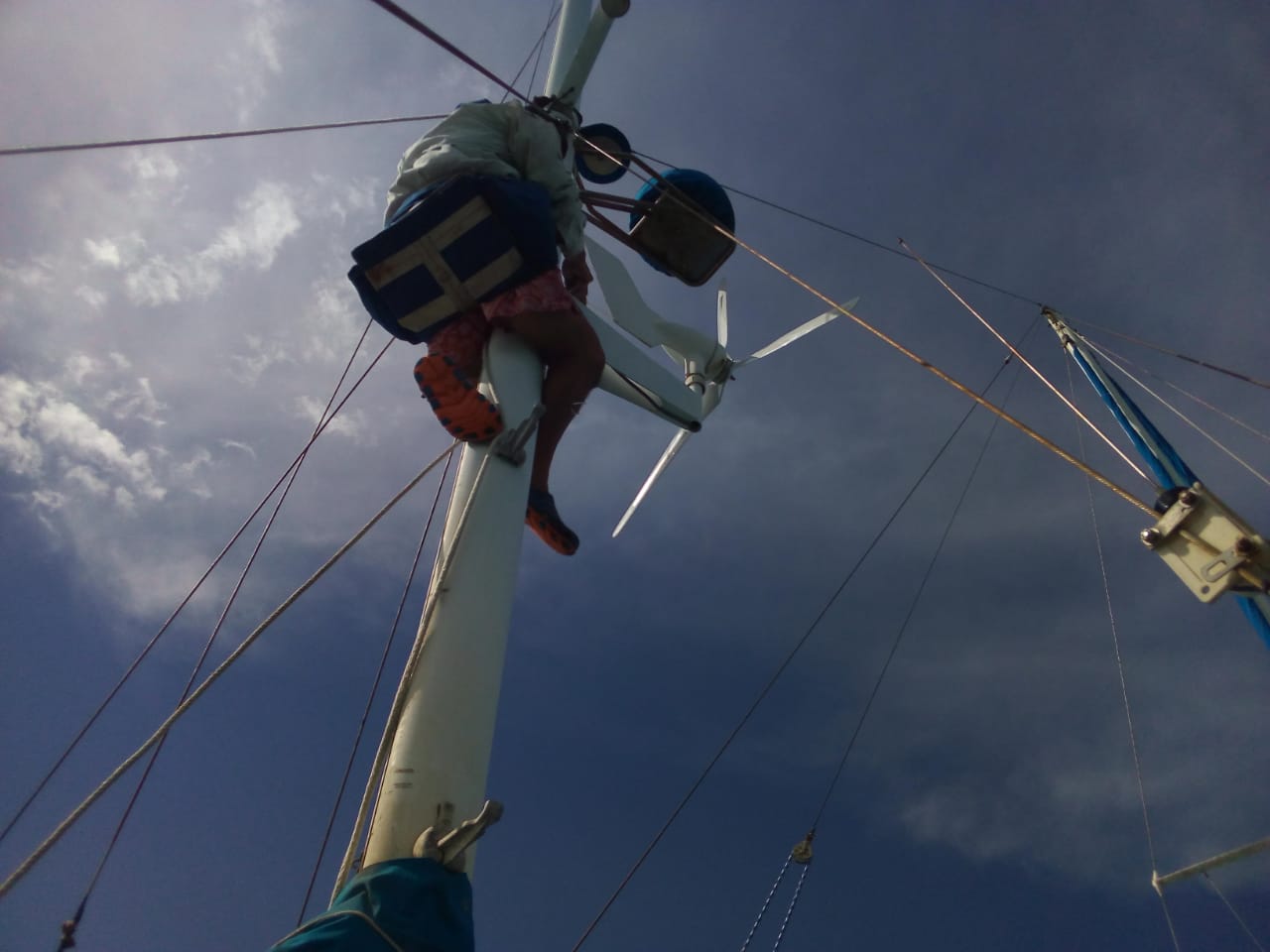 Breeze replacing blades on wind generator.jpg