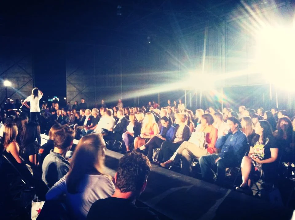 300+ guests watch models strut their stuff on the runway at the University Air Center