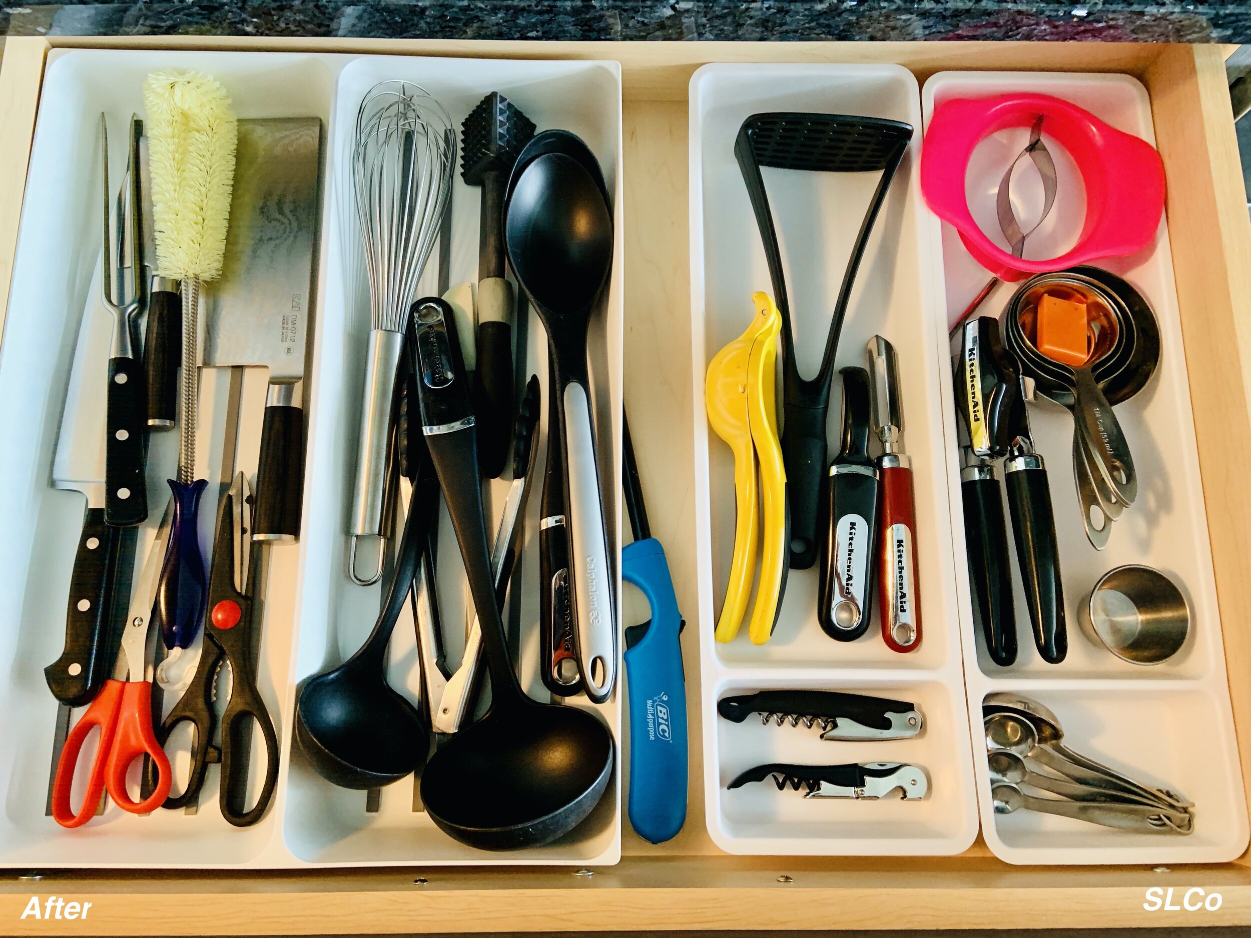 Kitchen drawer with random utensils organized into white small containers