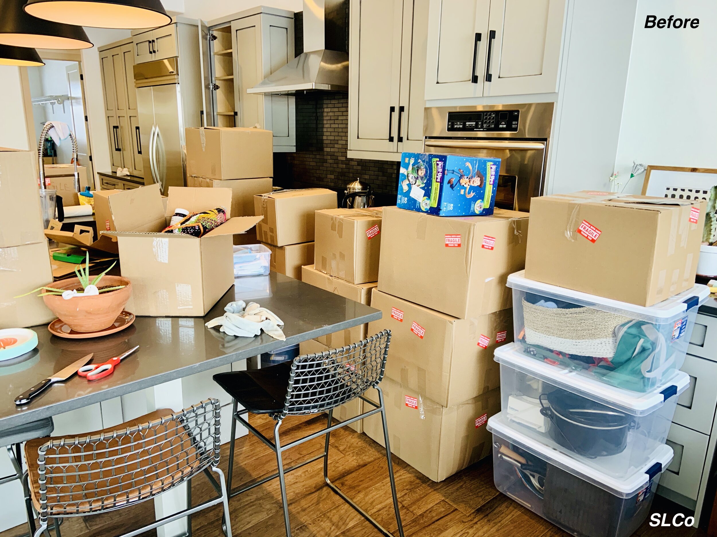 Large kitchen filled with boxes of kitchen items to be unpacked