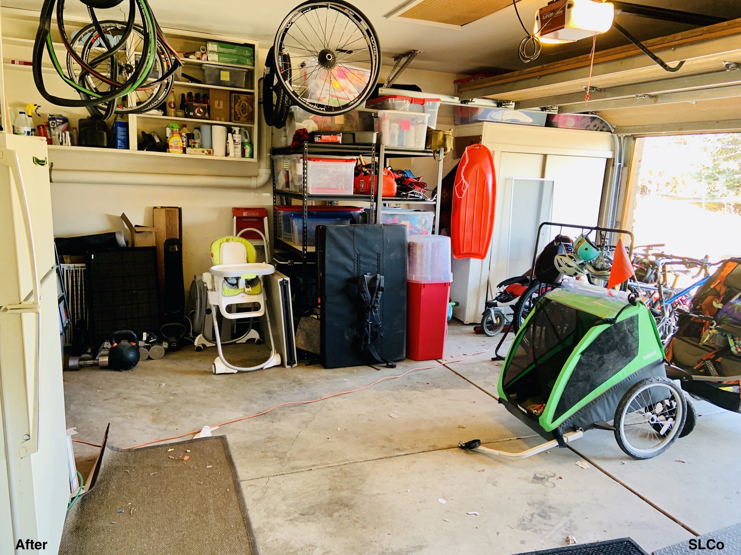 After photo of garage with items nearly placed along walls and on metal shelving units, bikes and strollers to the side