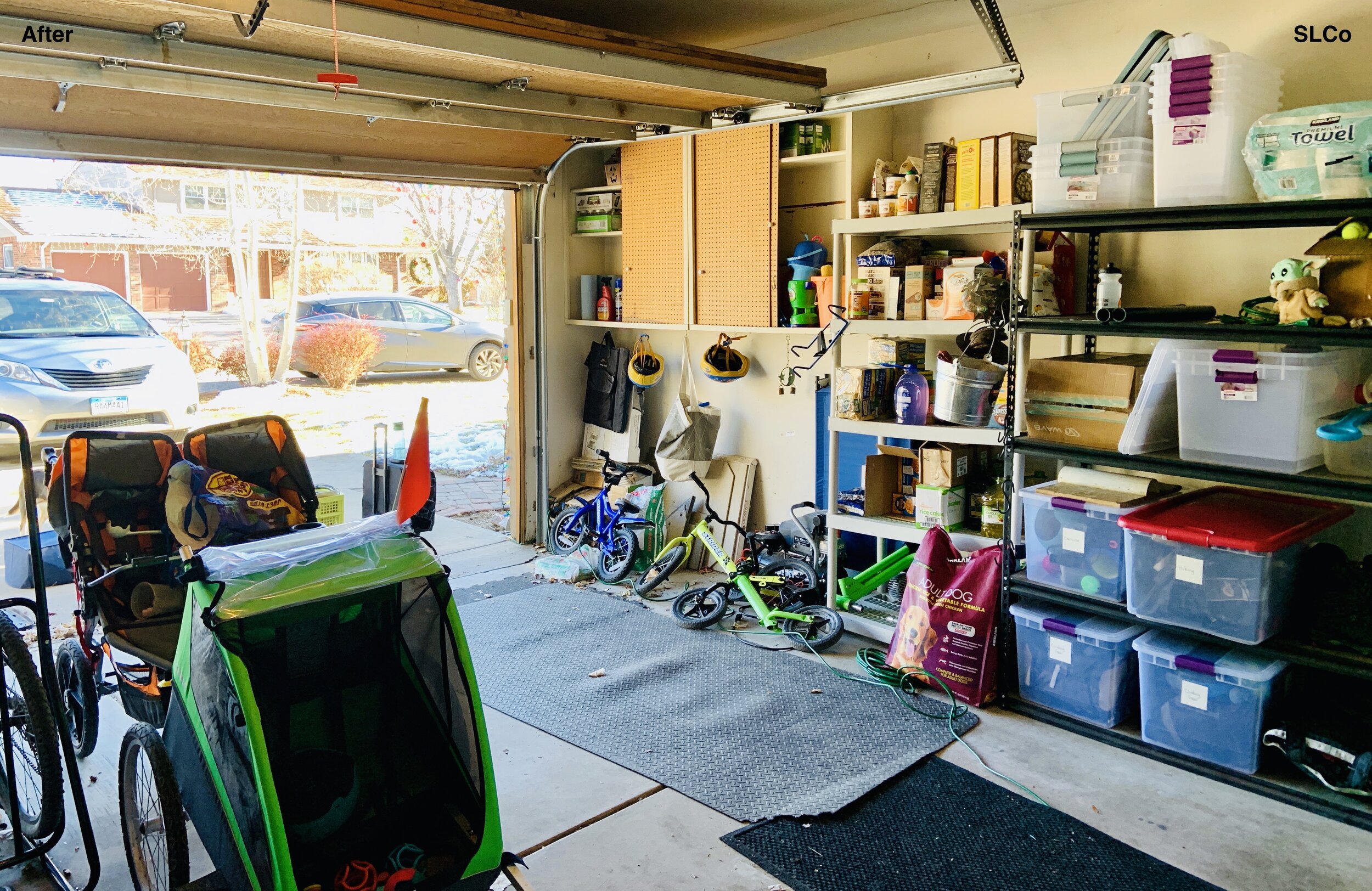 After photo of garage with items nearly placed along walls and on metal shelving units, bikes and strollers to the side