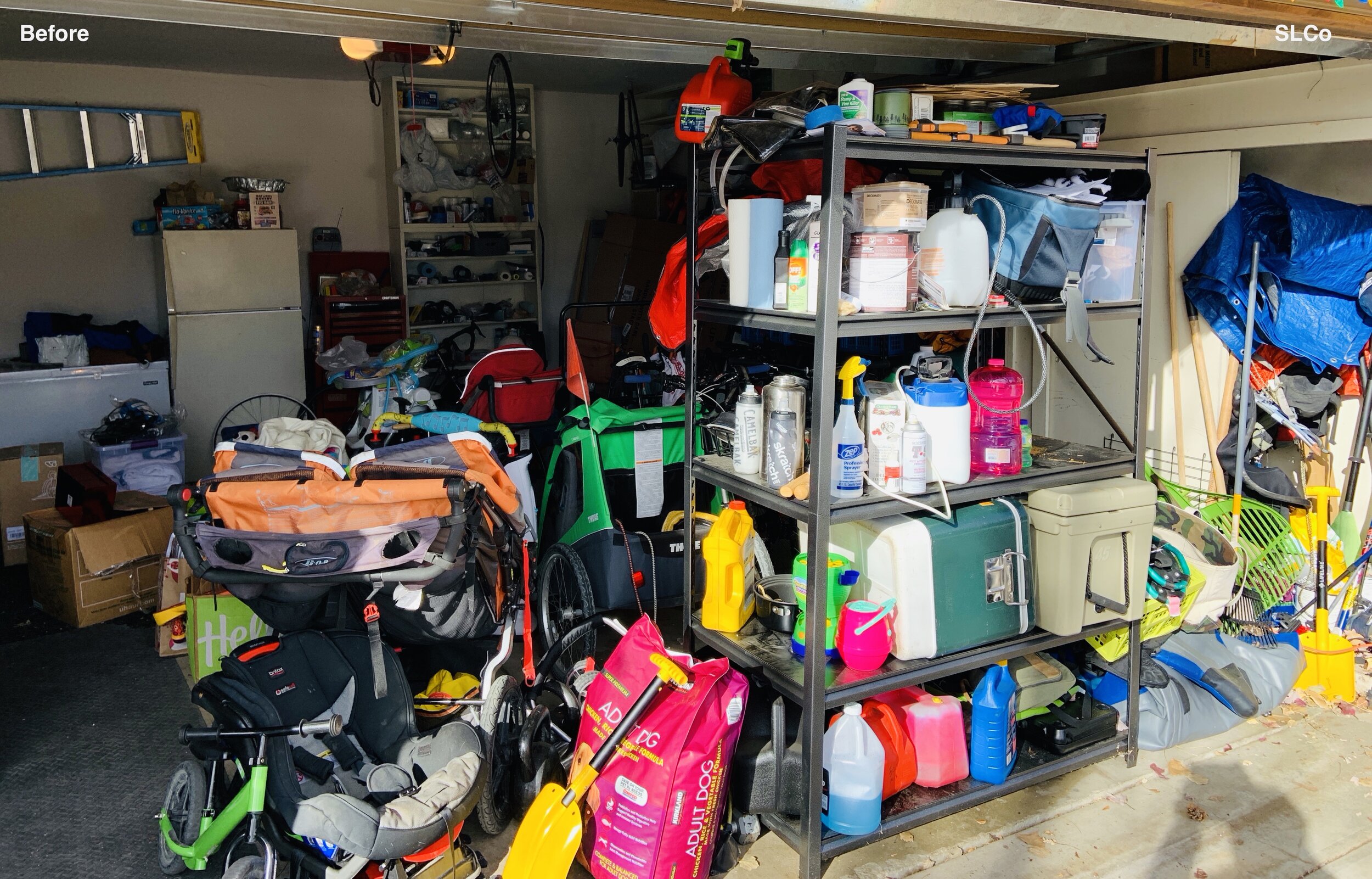 Before photo of garage from garage door with shelving unit with cleaning supplies stacked and strollers and bikes stacked 3ft high